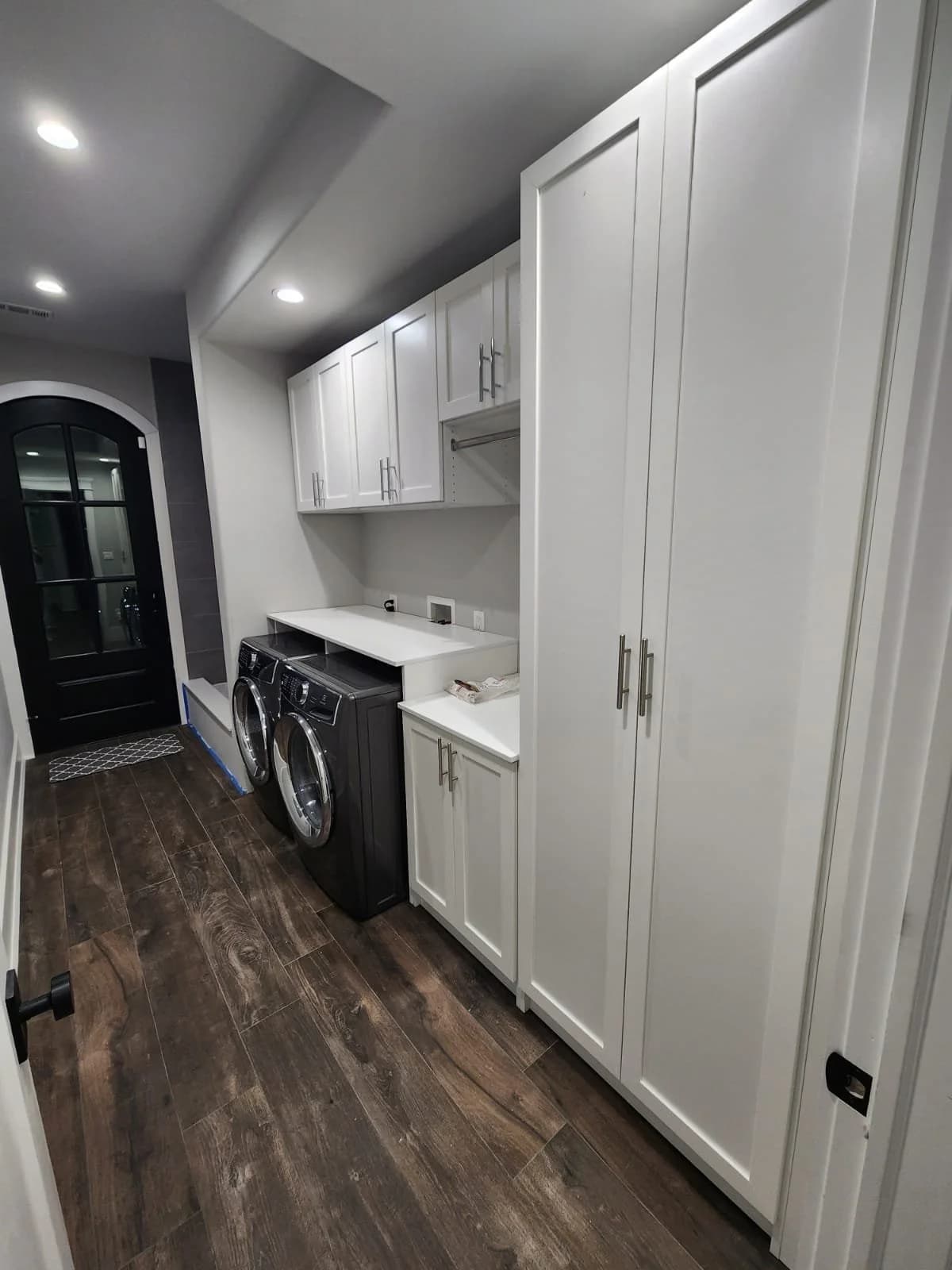 Custom laundry room with cabinets and washer-dryer