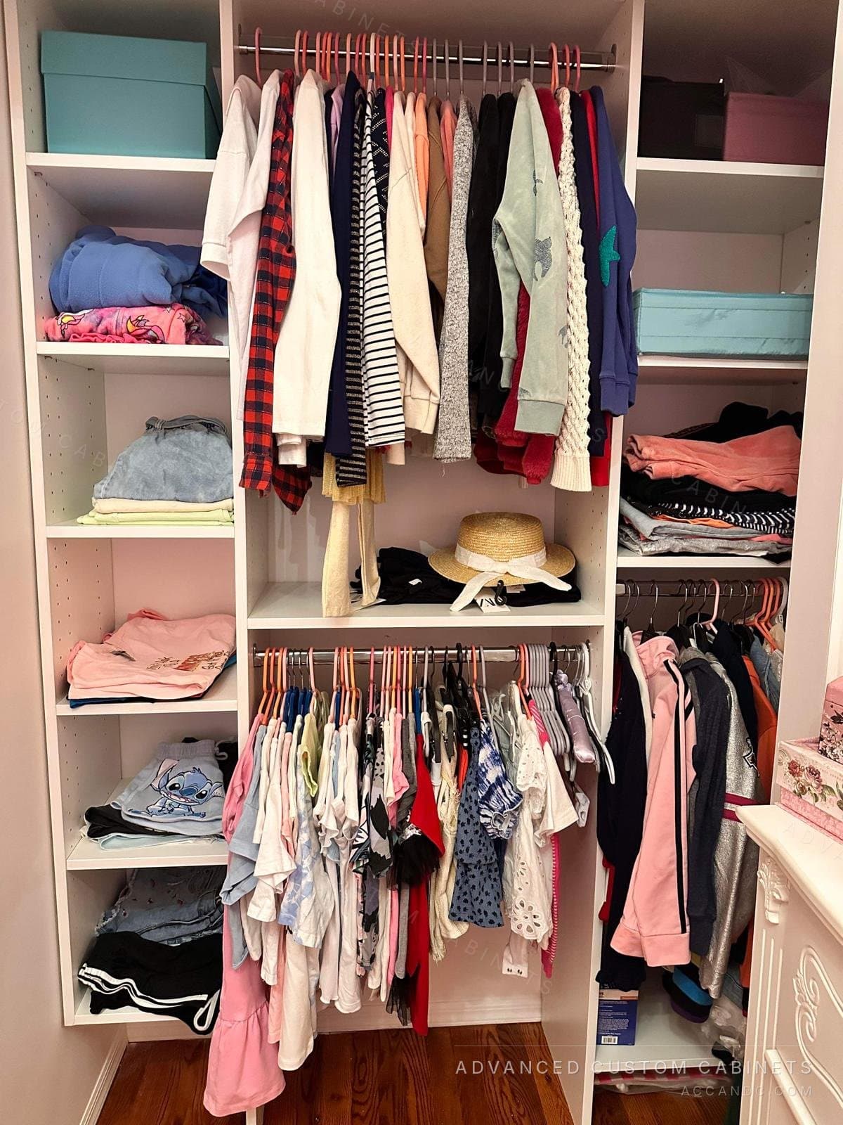 Kids white reach-in closet with double hanging rods and side shelves