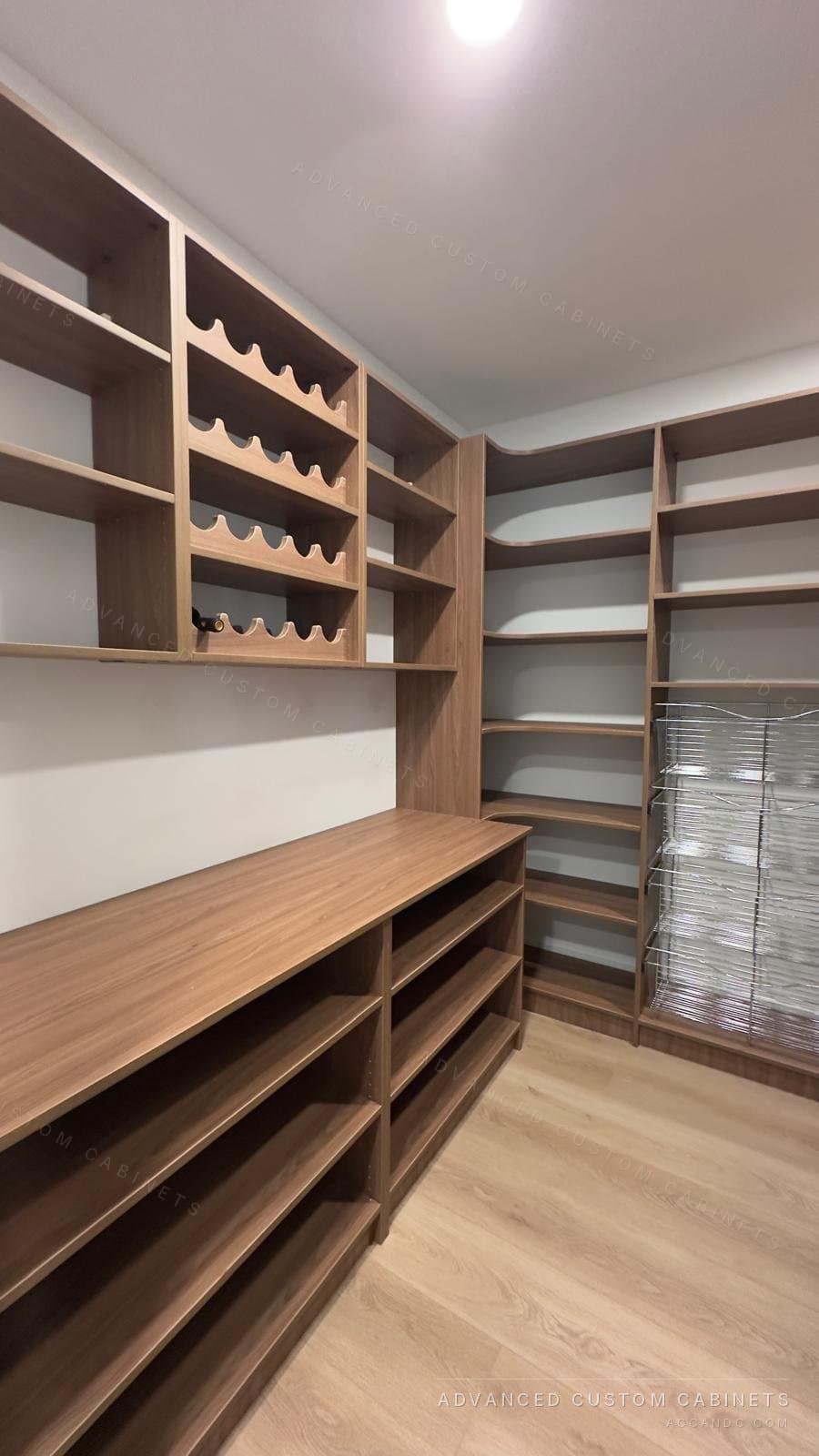 Custom walk-in pantry in wood finish with a wine rack, open shelving, a counter, and pull-out wire baskets