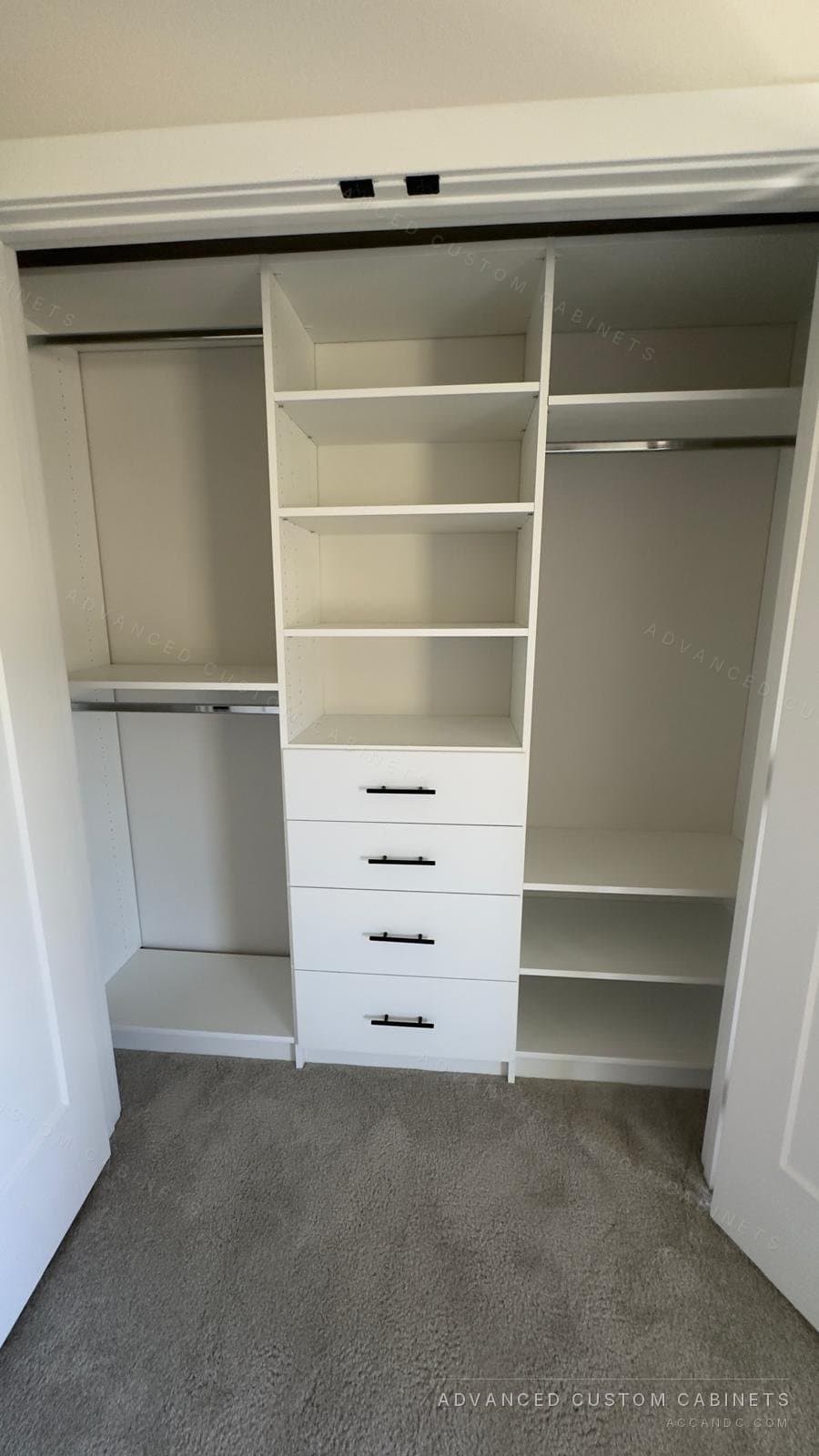 White reach-in closet with a center tower of open shelves over four drawers, double hanging on the left and a hanging rod over shelves on the right