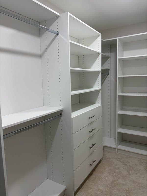White walk-in closet system with open shelves, drawers and hanging rods
