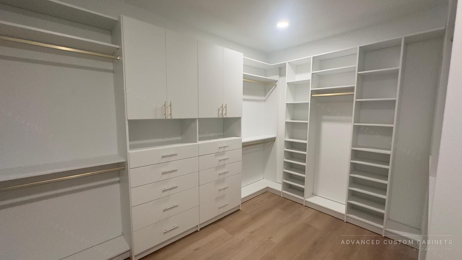 Custom white walk-in closet with brass hanging rods, a double bank of drawers, open shelving, and corner shoe shelves