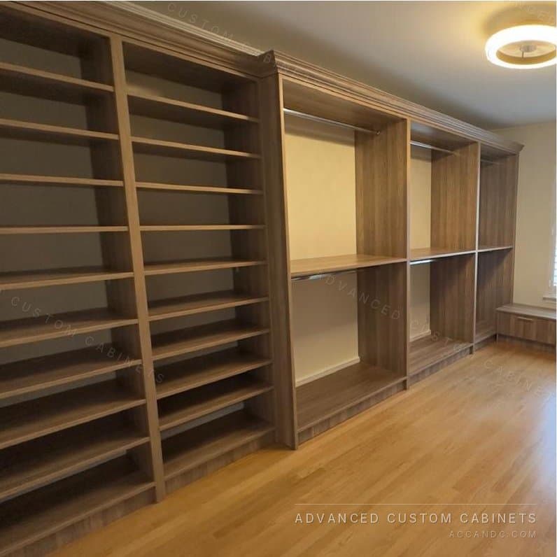 Custom walk-in closet wall of angled shoe shelves in a wood finish, with adjustable hanging sections alongside