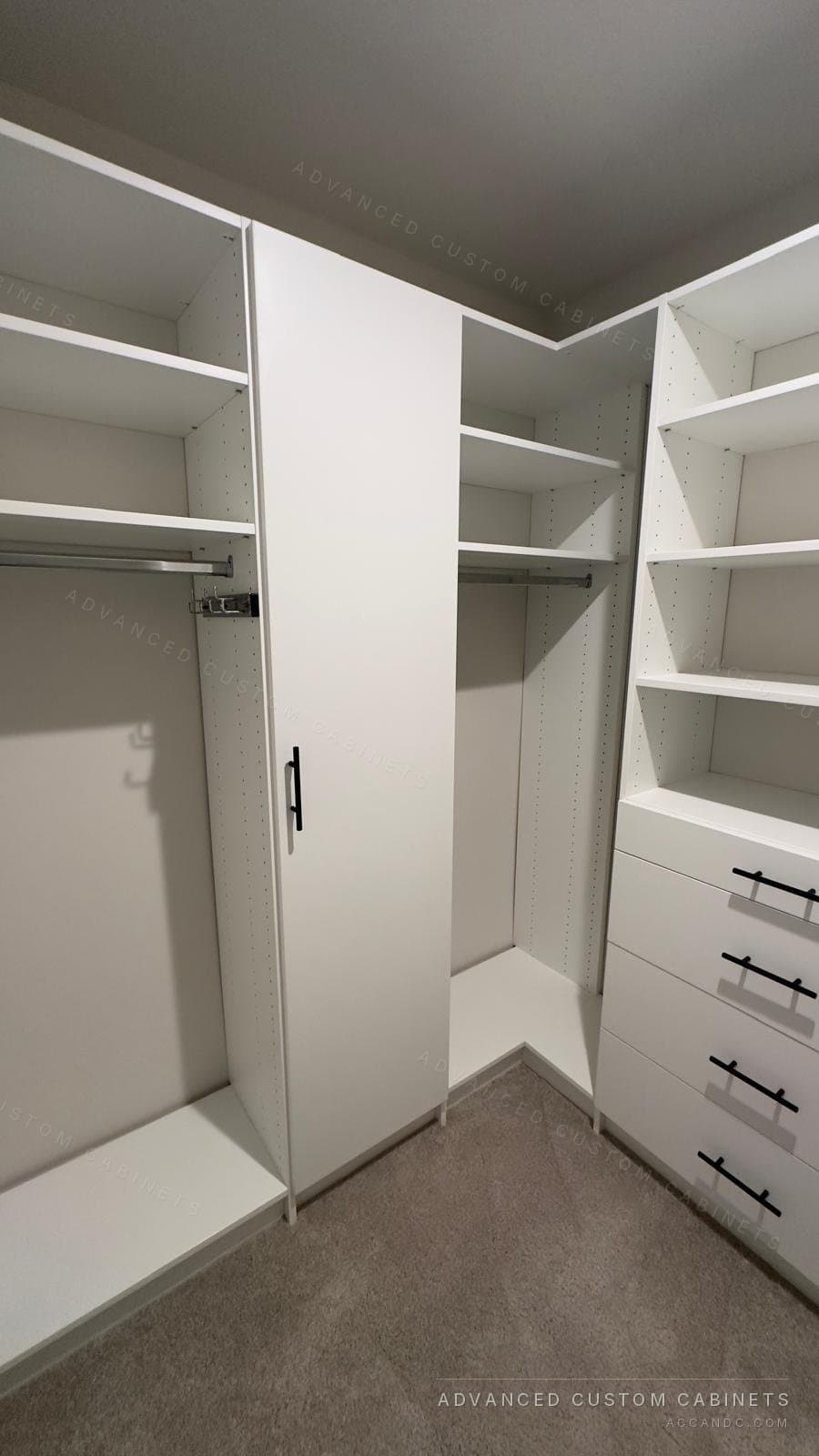 White walk-in closet with a full-height door cabinet, a pull-out accessory rack, corner hanging sections and a four-drawer chest with black bar pulls