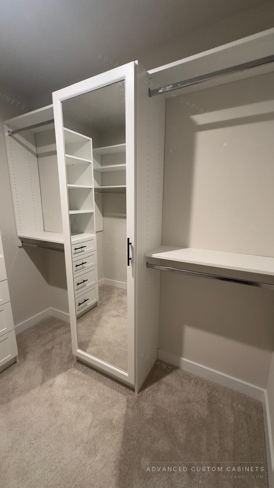 Corner white walk-in closet with mirrored-door tower, four-drawer base, adjustable corner shelving, and dual hanging rods