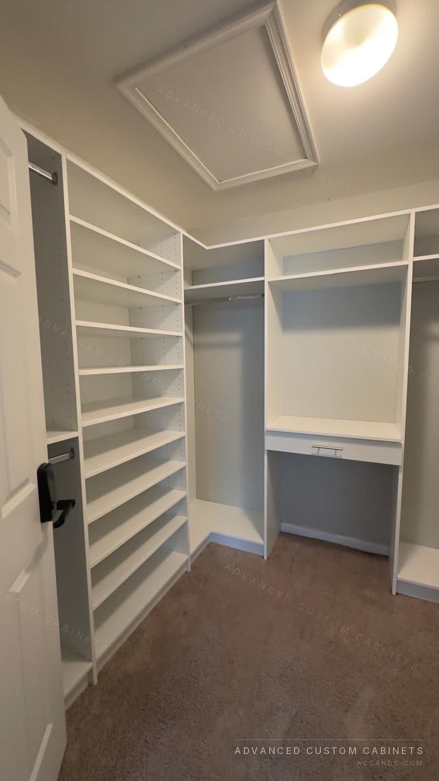 Custom white walk-in closet with adjustable shelving, built-in bench and hanging sections