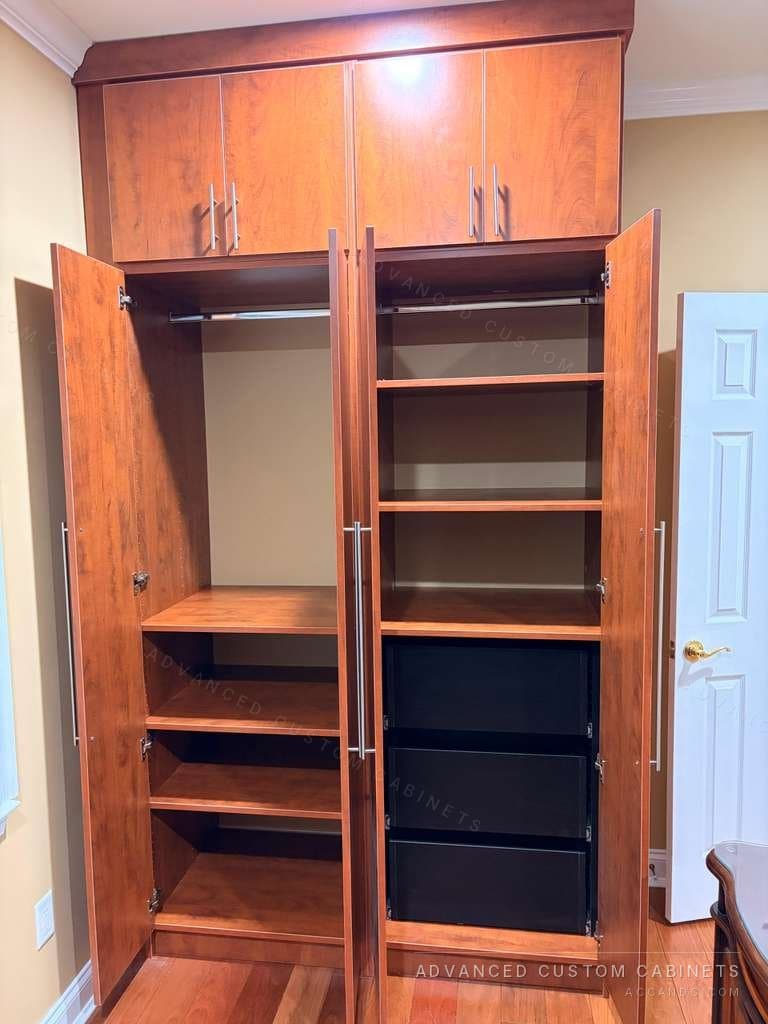 Custom cherry-finish wardrobe interior with adjustable shelves, hanging rods and pull-out drawers