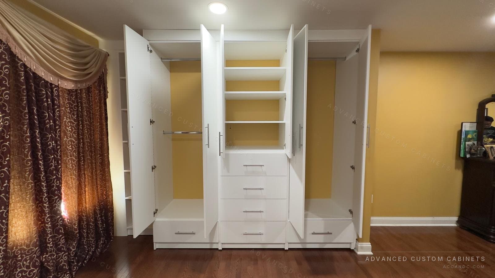White wardrobe with the doors open, showing adjustable shelves, a centre four-drawer stack and two hanging sections