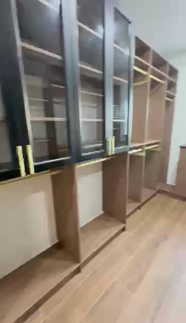 Walk-in closet with black glass-front cabinets and light oak drawers, filmed on install day, video walkthrough